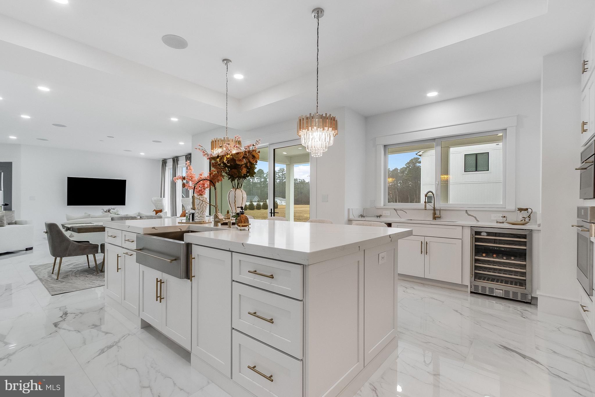 20157 West Piney Grove Road Georgetown, DE 19947 - Photo 9 of 104 a large white kitchen with a white countertops a stove and a flat screen tv