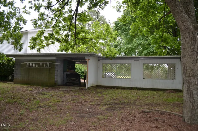 a view of a house with a tree and a yard