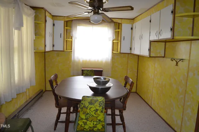 a view of a dining room with furniture and a window