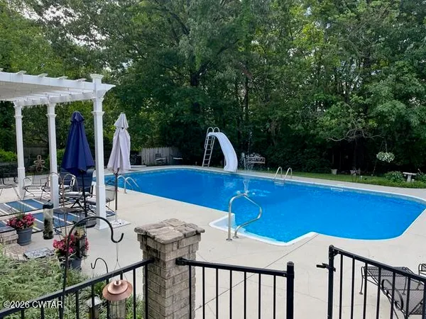 a view of swimming pool with a yard