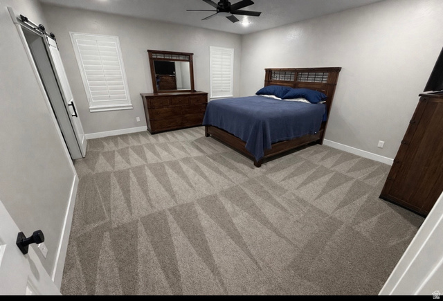 2350 North 1075 West Helper, UT 84526 - Photo 14 of 49 Bedroom with a barn door, a ceiling fan, recessed lighting, and light colored carpet