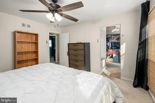 a bedroom with a bed and a flat tv screen