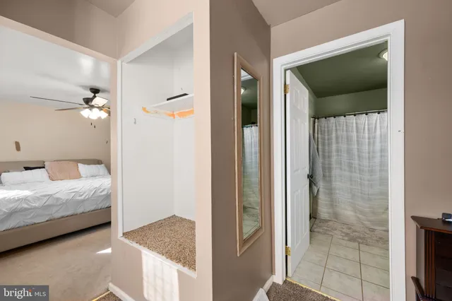 a en suite bathroom with a granite countertop sink and a shower