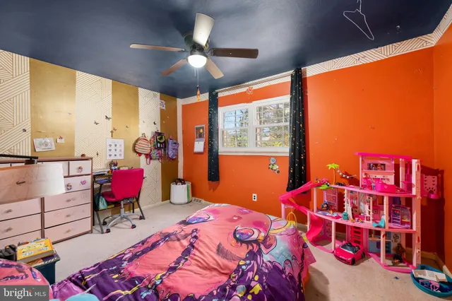a bedroom with furniture and a large window