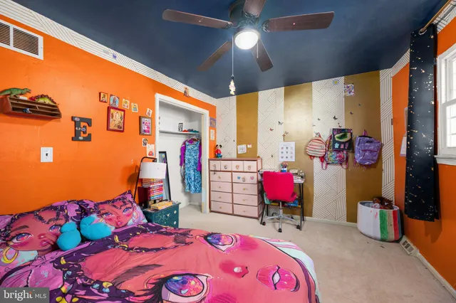 a very nice looking bedroom with a large bed and a chandelier