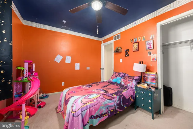 a bedroom with a bed and a lamp