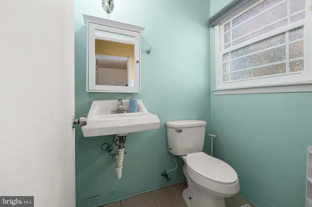 a bathroom with a sink toilet and mirror