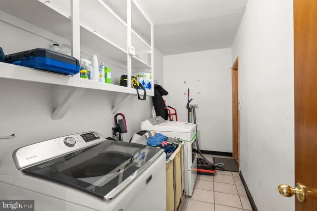 a kitchen with a stove and wooden floor