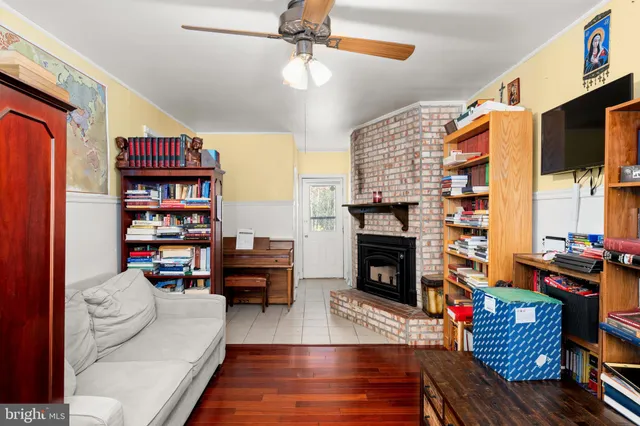 a living room with furniture fireplace and rug