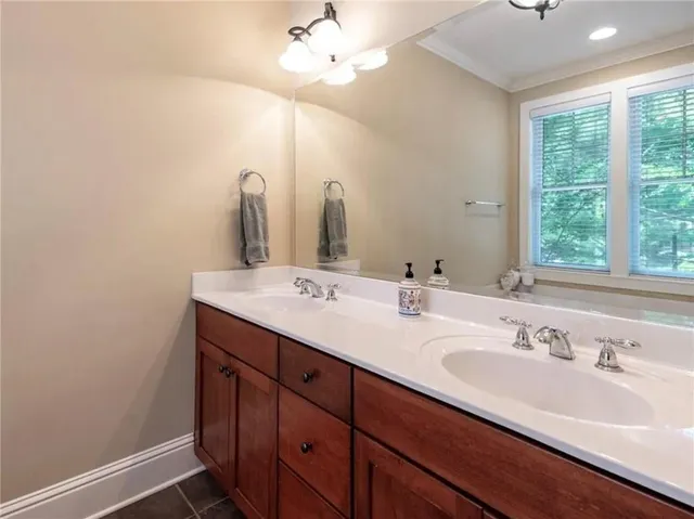 a bathroom with a double vanity sink and a mirror