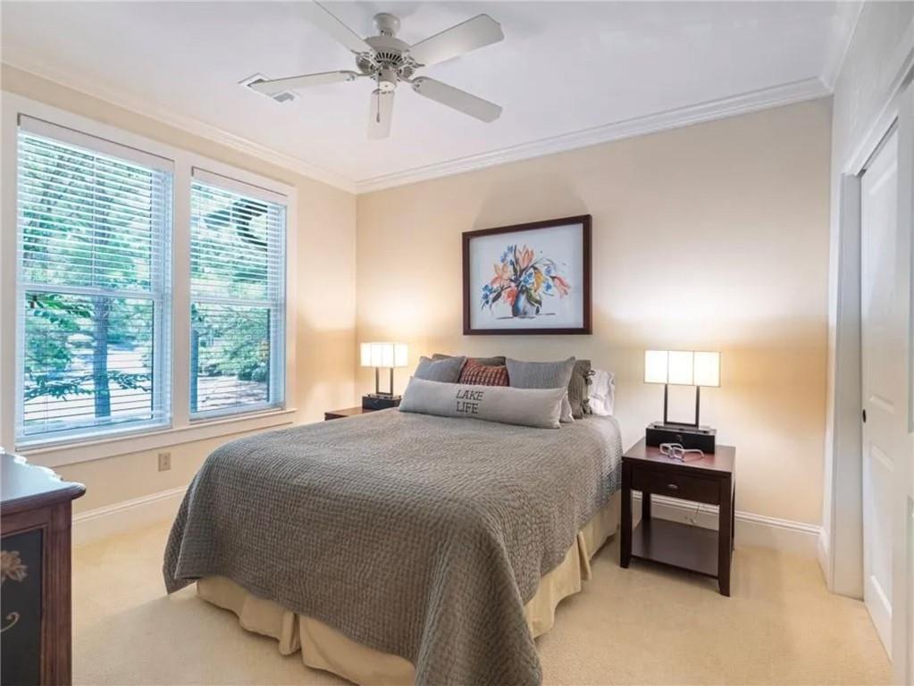 1060 Tailwater, Unit F Greensboro, GA 30642 - Photo 19 of 24 a bedroom with a bed and a painting on the wall