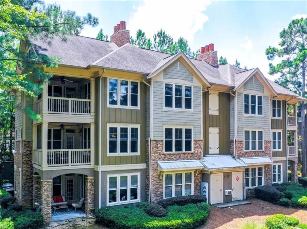 1060 Tailwater, Unit F Greensboro, GA 30642 - Photo 20 of 24 a view of a white house with a yard and potted plants