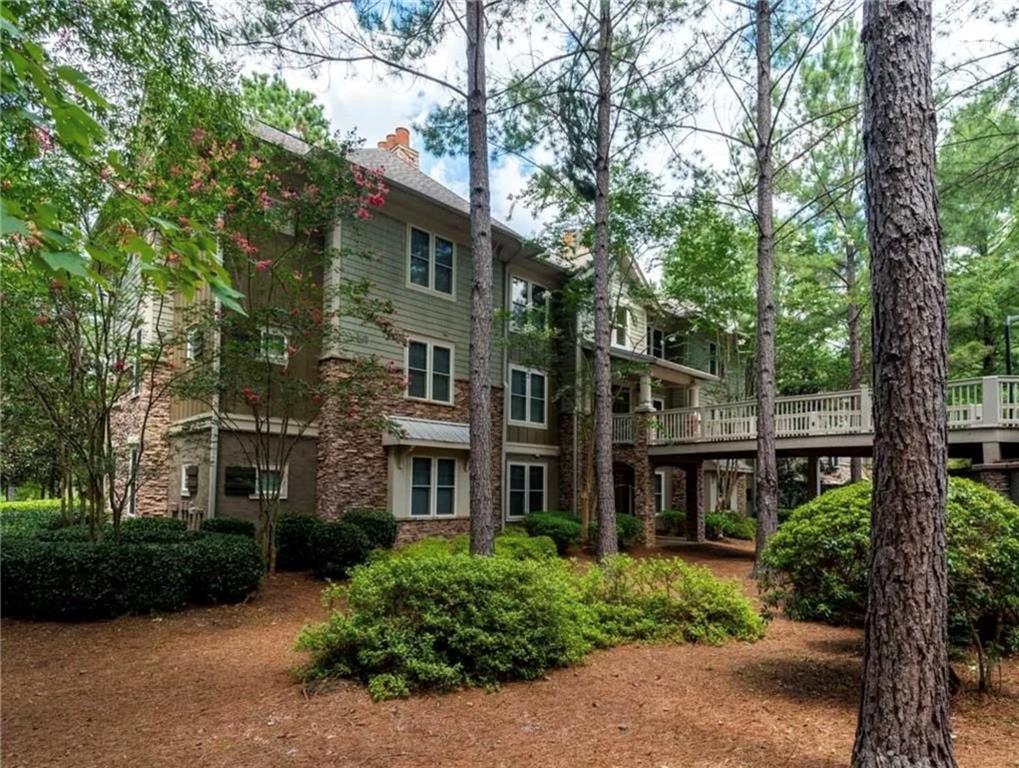 1060 Tailwater, Unit F Greensboro, GA 30642 - Photo 21 of 24 a front view of a house with a garden