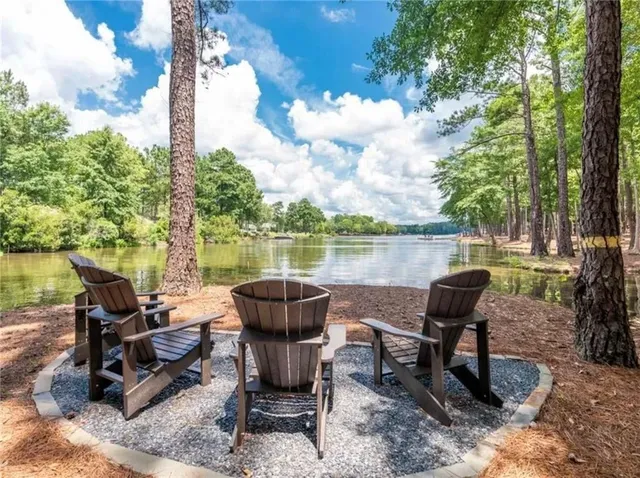 a view of a lake with table and chairs
