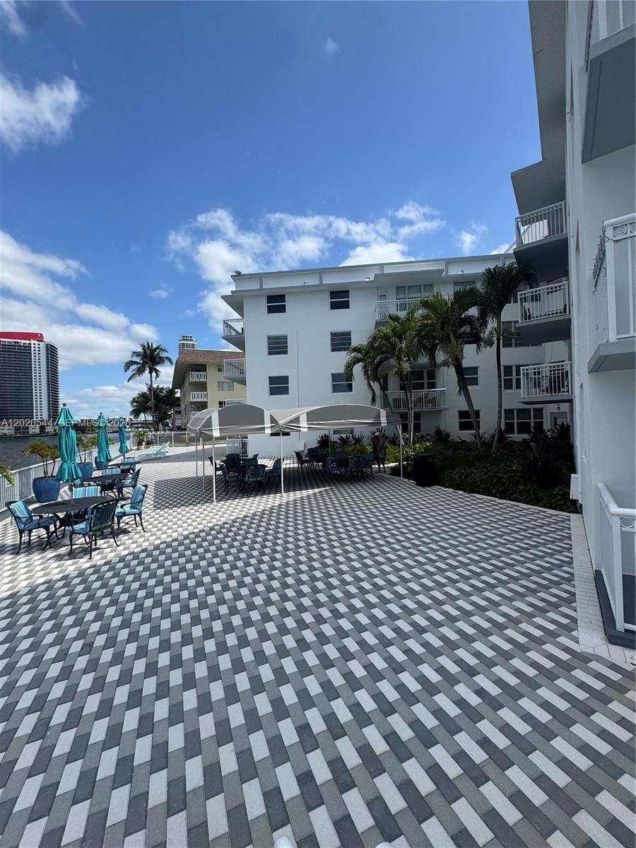 1913 South Ocean Drive, Unit 427 Hallandale Beach, FL 33009 - Photo 4 of 16 a view of a chairs and tables in a patio