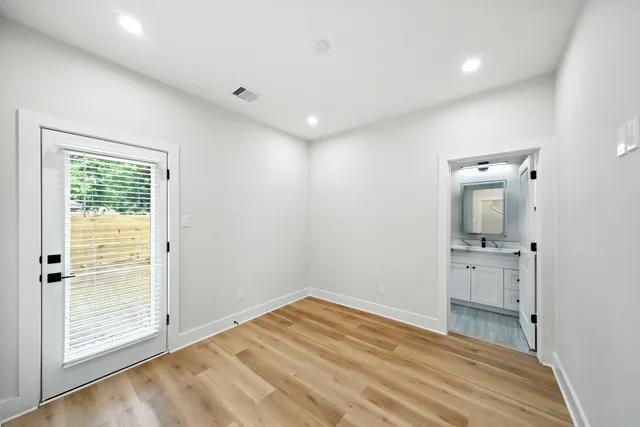 wooden floor in an empty room with a window