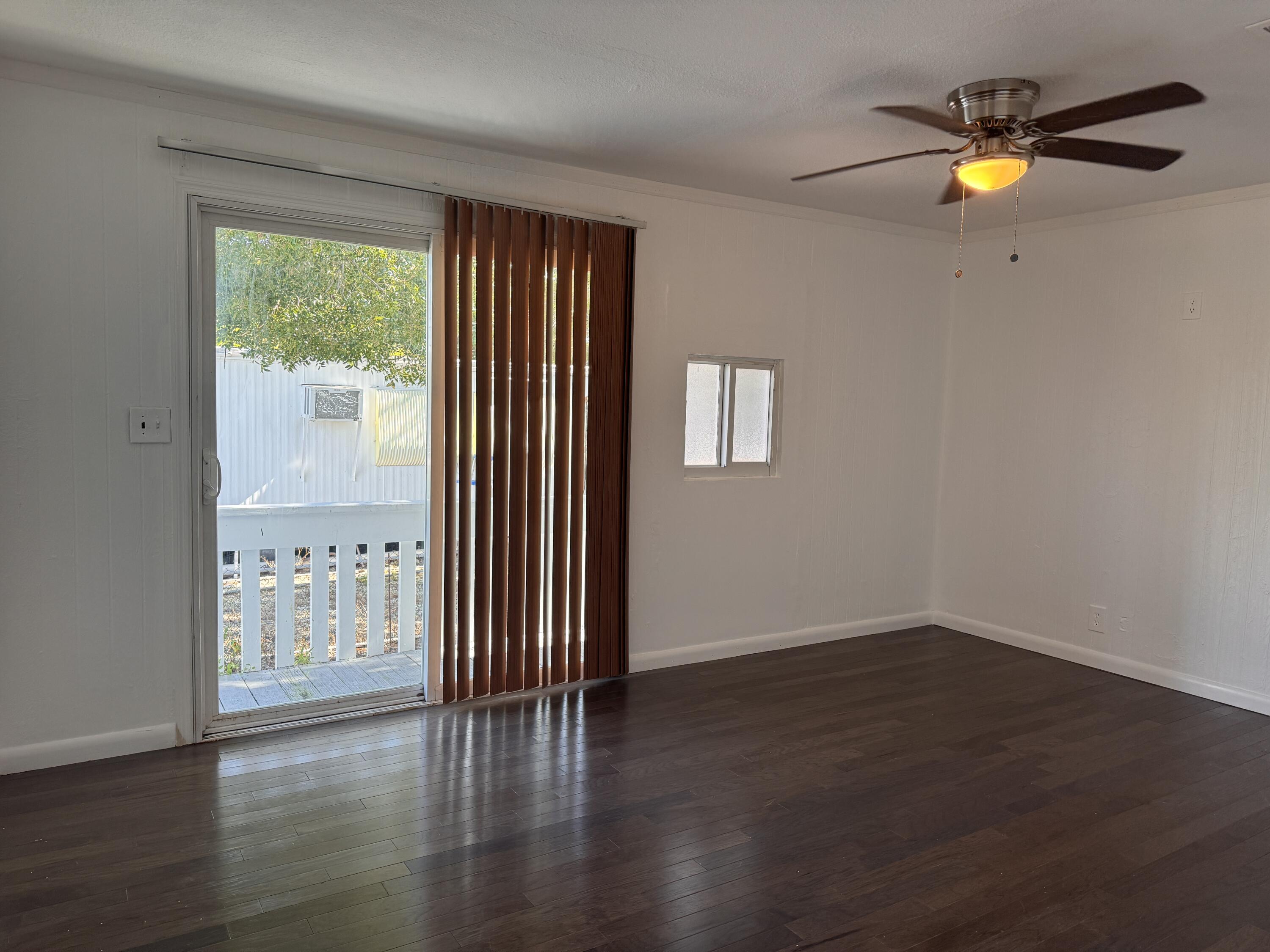 969 Plantation Road Key Largo, FL 33037 - Photo 5 of 26 a view of an empty room with wooden floor and a window