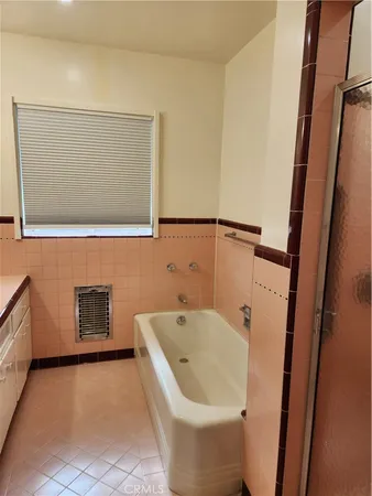a bathroom with a bathtub and shower