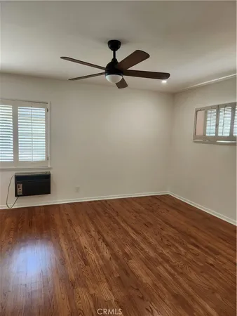 a view of a livingroom with wooden floor and a window