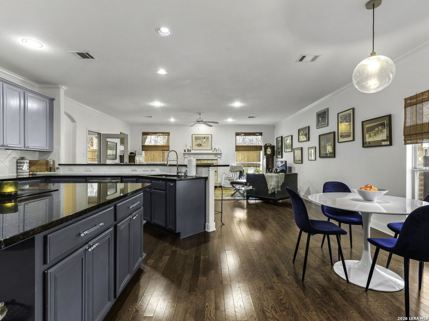 16107 La Madera Rio Helotes, TX 78023 - Photo 11 of 39 a kitchen with stainless steel appliances granite countertop a refrigerator a sink dishwasher a dining table and chairs with wooden floor