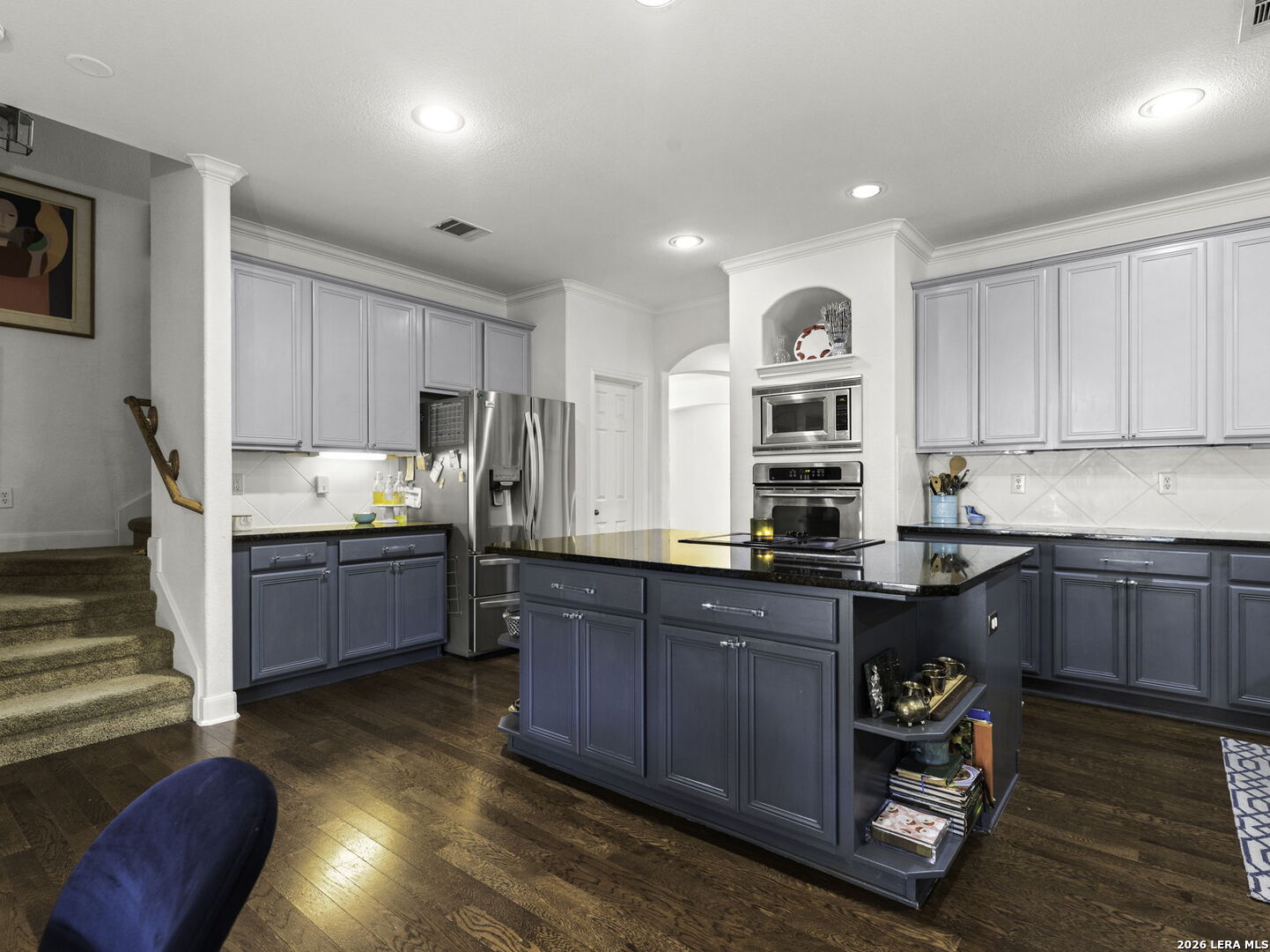 16107 La Madera Rio Helotes, TX 78023 - Photo 17 of 39 a kitchen with stainless steel appliances granite countertop a sink a stove a refrigerator cabinets and wooden floor