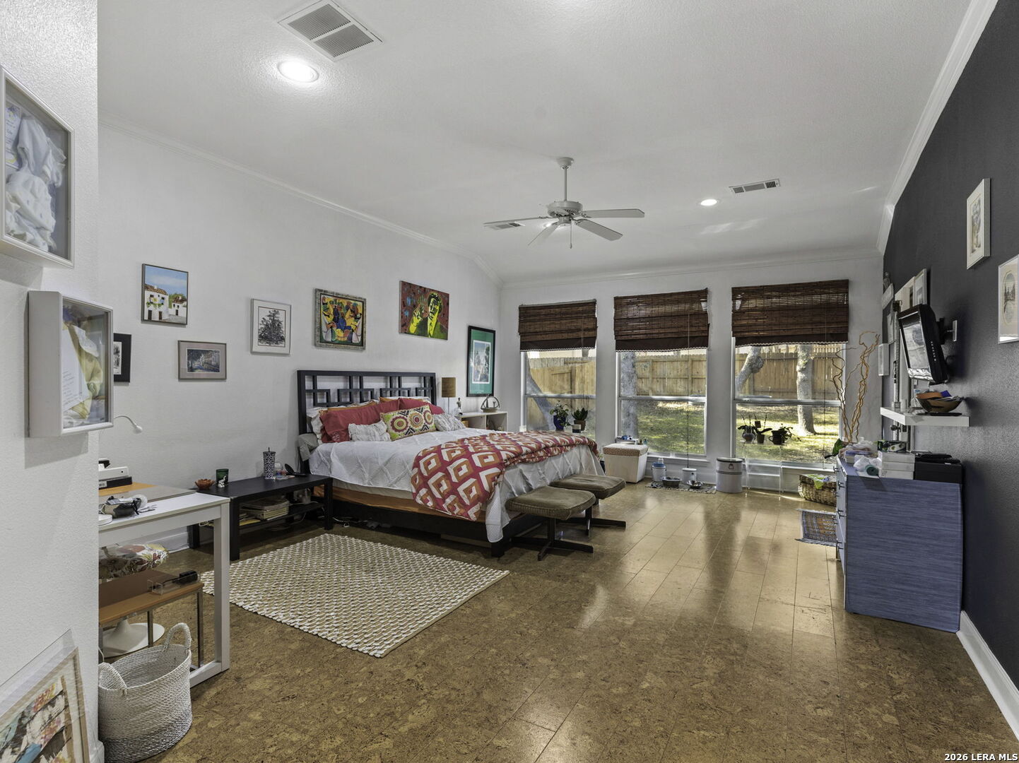 16107 La Madera Rio Helotes, TX 78023 - Photo 18 of 39 a spacious bedroom with a bed a couch and large window