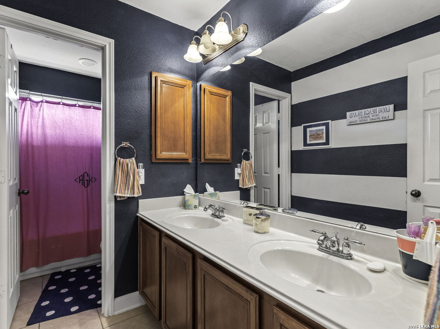 16107 La Madera Rio Helotes, TX 78023 - Photo 31 of 39 a bathroom with a double vanity sink and a mirror