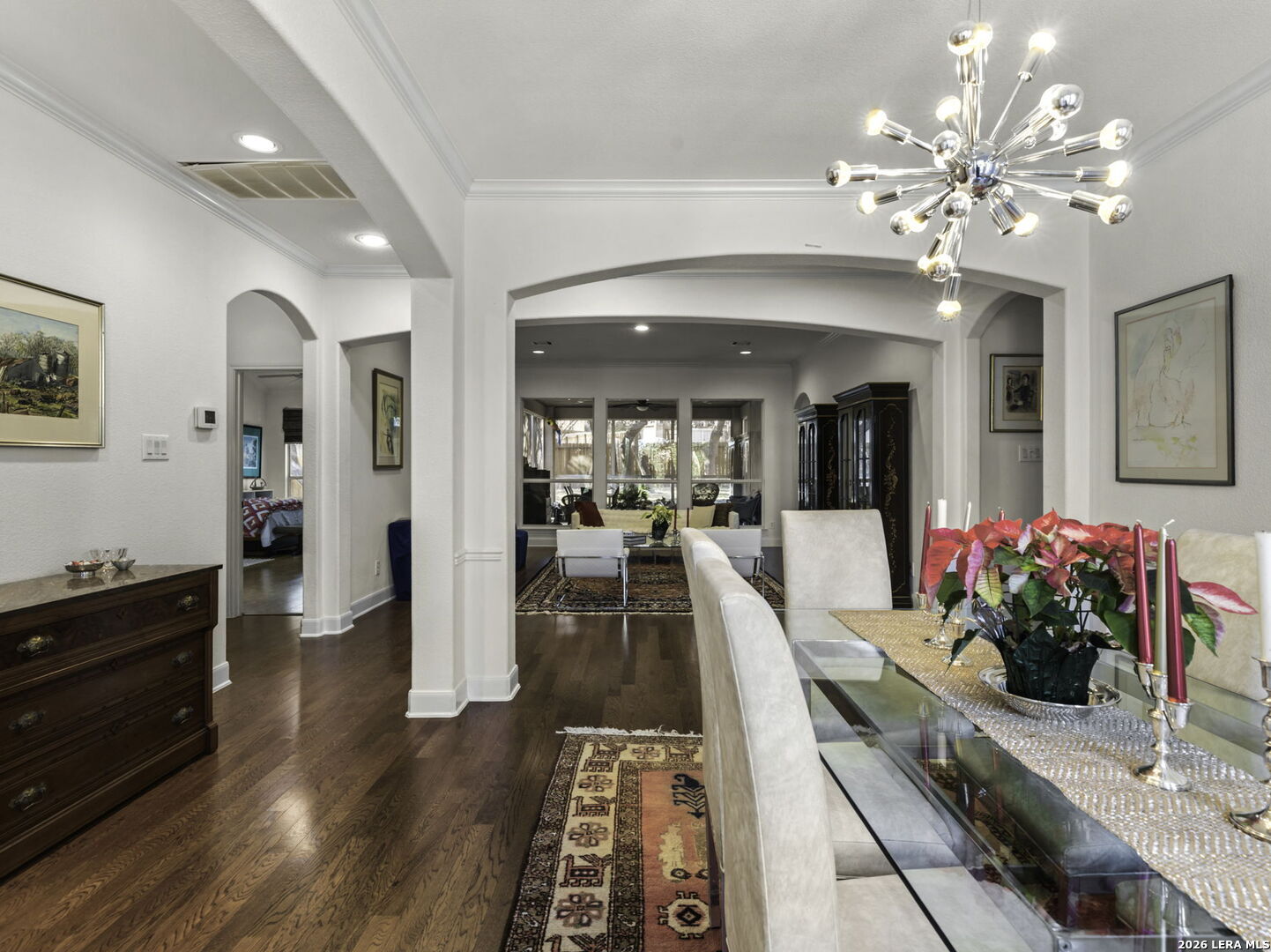 16107 La Madera Rio Helotes, TX 78023 - Photo 4 of 39 a dining hall with a dining table a chandelier and wooden floor