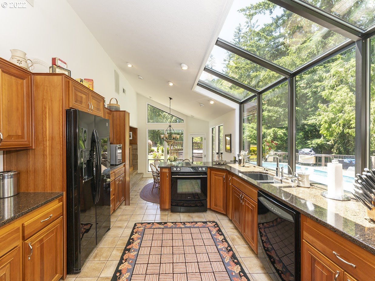 6562 South Zimmerman Road Aurora, OR 97002 - Photo 18 of 31 a large kitchen with a large window and stainless steel appliances
