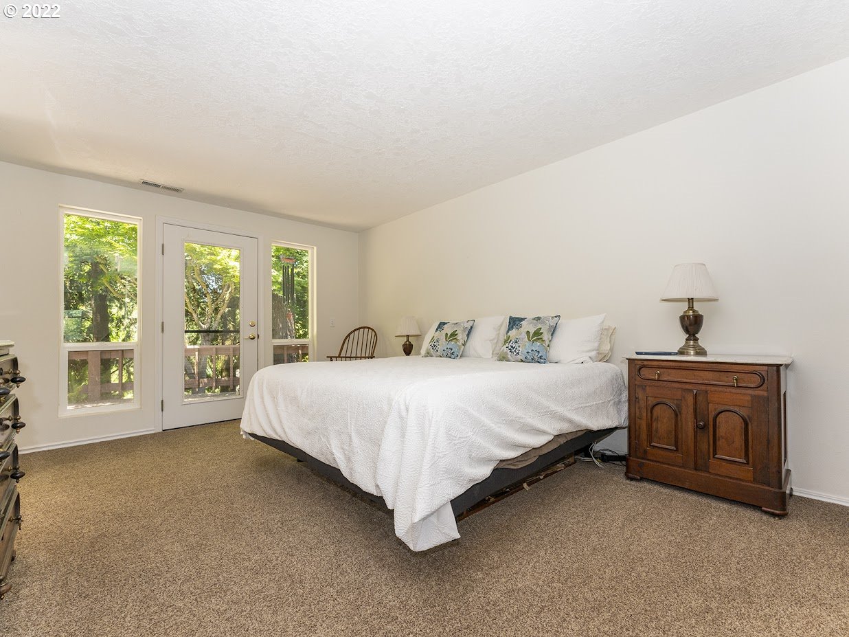 6562 South Zimmerman Road Aurora, OR 97002 - Photo 21 of 31 a spacious bedroom with a bed and a fireplace