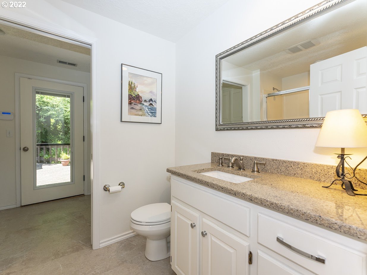 6562 South Zimmerman Road Aurora, OR 97002 - Photo 27 of 31 a bathroom with a granite countertop sink mirror vanity and toilet
