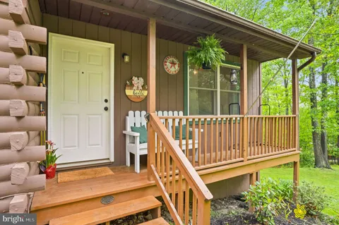 a view of a house with a small deck