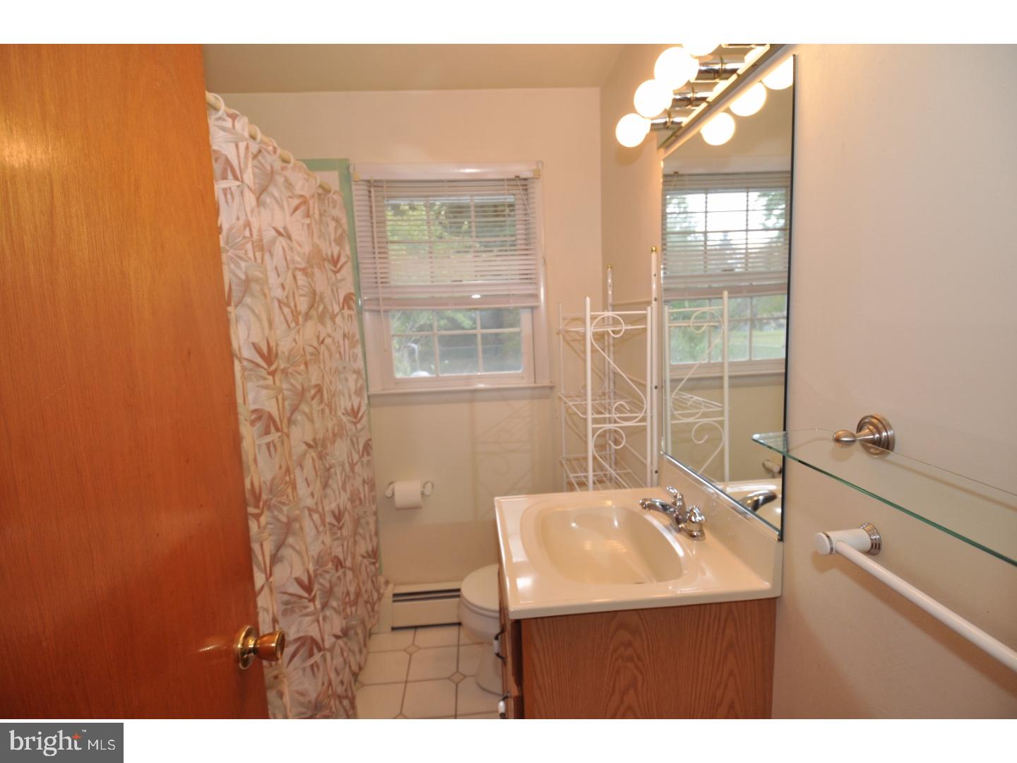 472 Station Road Roebling, NJ 08554 - Photo 11 of 25 a bathroom with a sink a mirror and a shower
