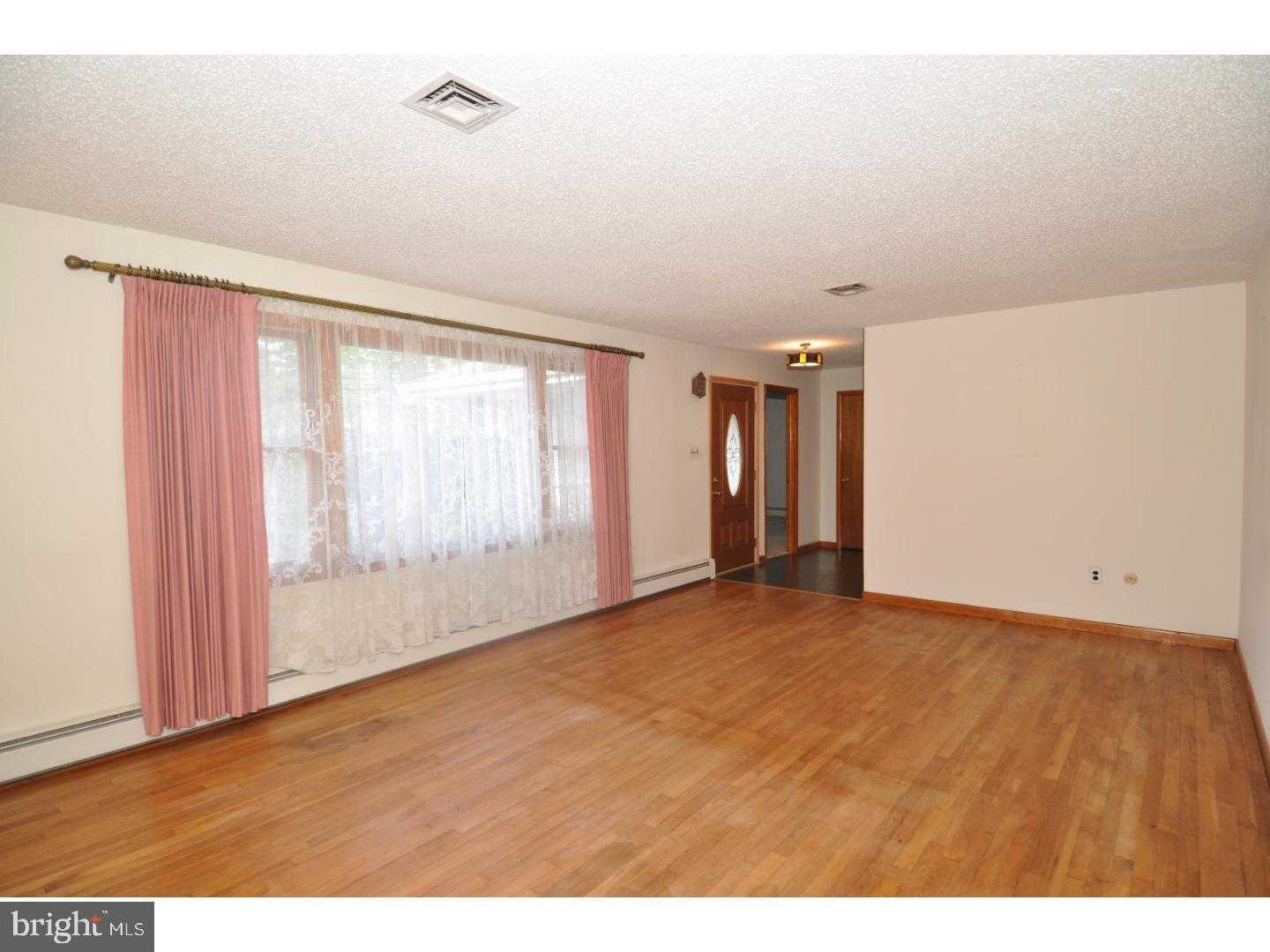 472 Station Road Roebling, NJ 08554 - Photo 9 of 25 a view of an empty room with wooden floor and a window