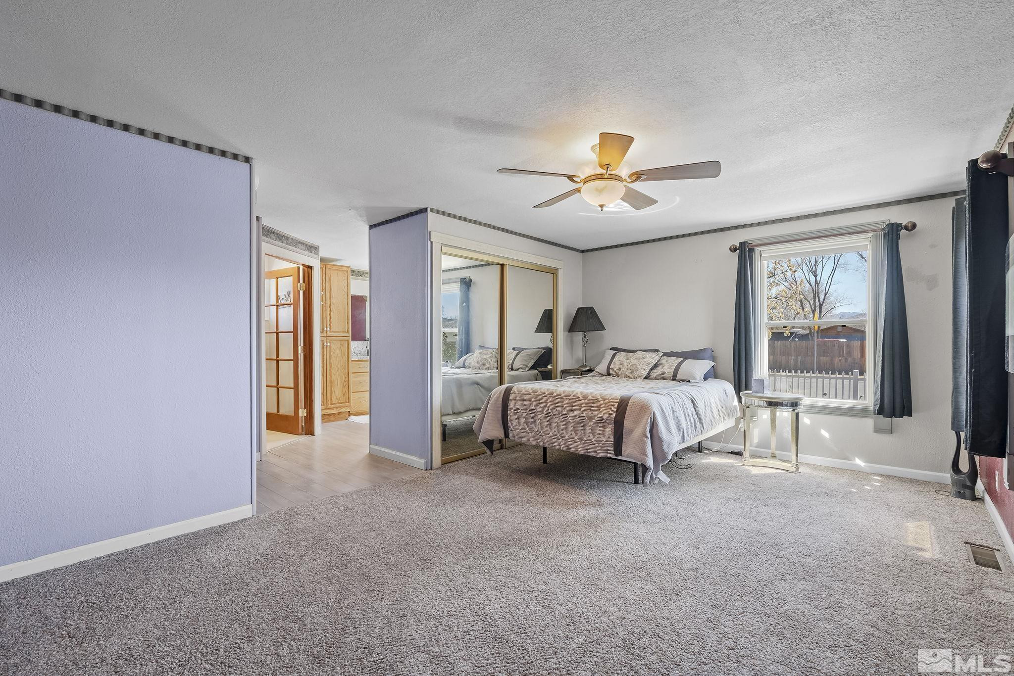 2 Lida Circle Carson City, NV 89706 - Photo 20 of 40 a spacious bedroom with a bed and a chandelier