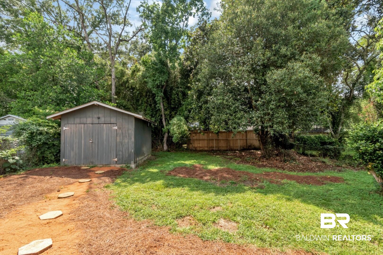 212 Morgan Avenue Mobile, AL 36606 - Photo 15 of 15 View of yard featuring a storage unit