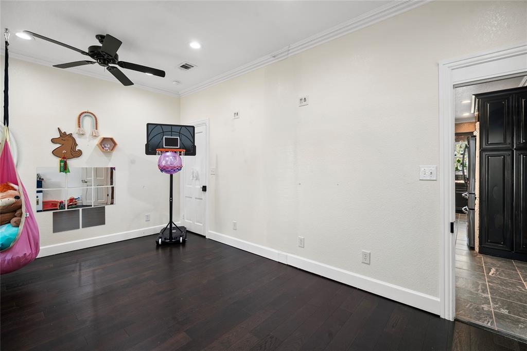 202 North Kickapoo Street Lipan, TX 76462 - Photo 18 of 38 Dark wood-finish flooring with white trim, a black ceiling fan, and recessed lighting