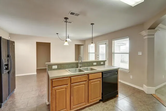 a bathroom with a granite countertop sink a mirror and a shower
