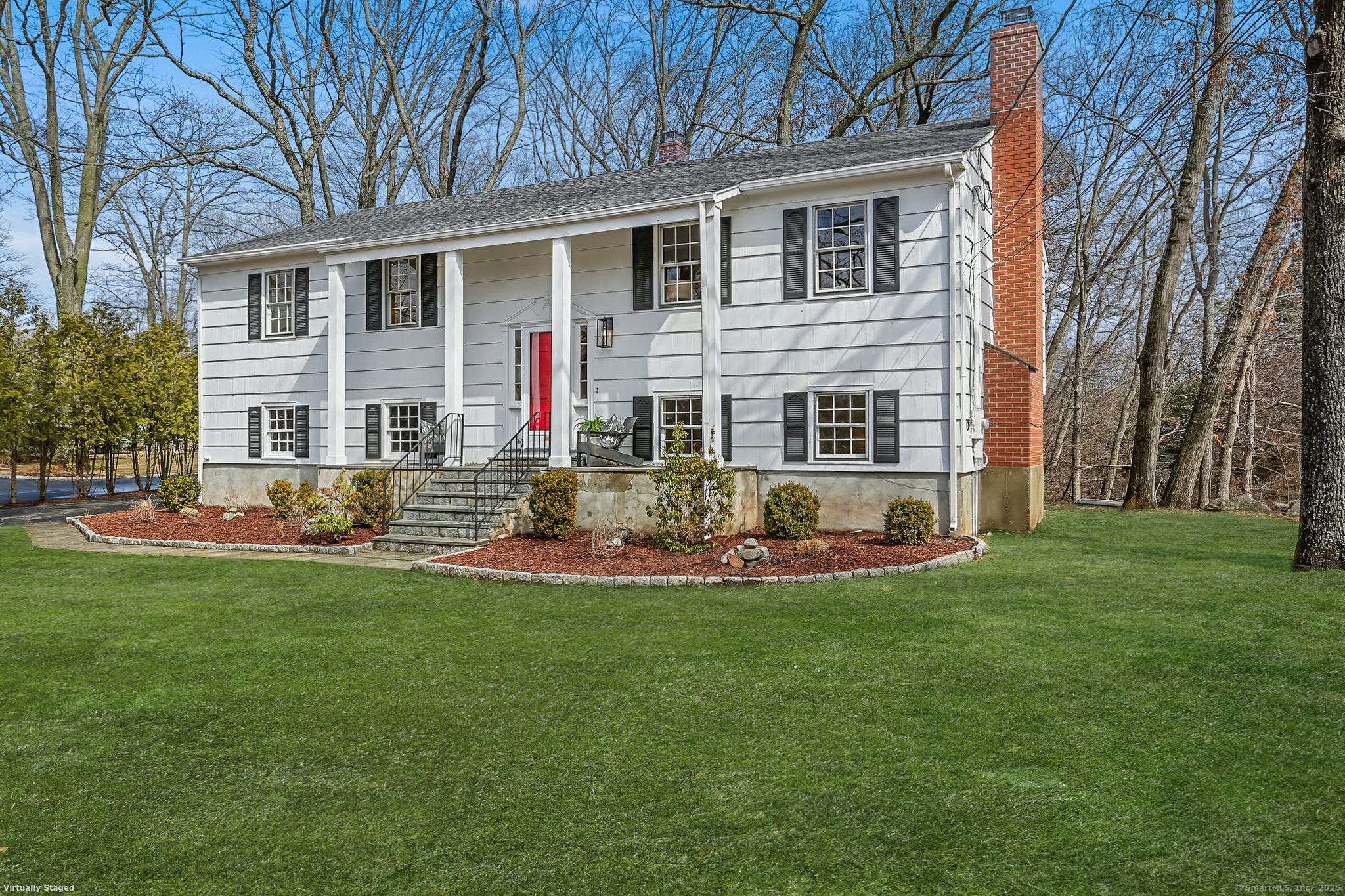 a front view of house with yard and outdoor seating
