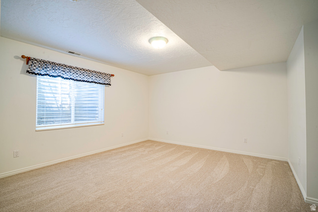 1433 Forge Way Draper, UT 84020 - Photo 23 of 29 Carpeted room featuring a single window with blinds and a valance, light-colored walls, and a ceiling-mounted light fixture
