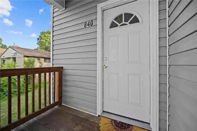 a view of front door and deck of the house
