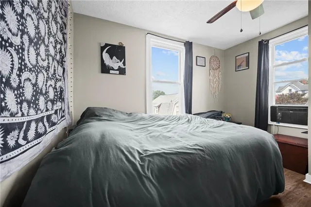 a bedroom with a bed and a window