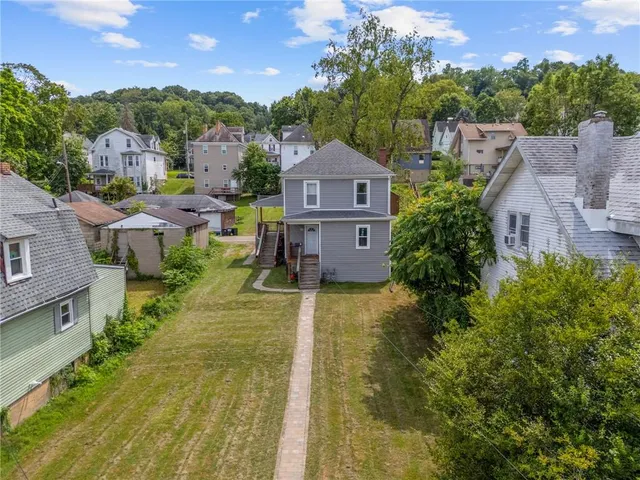 a view of a house with a yard and sitting area