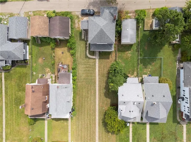 aerial view of a house with swimming pool and large trees