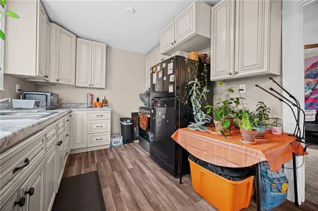 a kitchen with stainless steel appliances sink stove top oven and cabinets