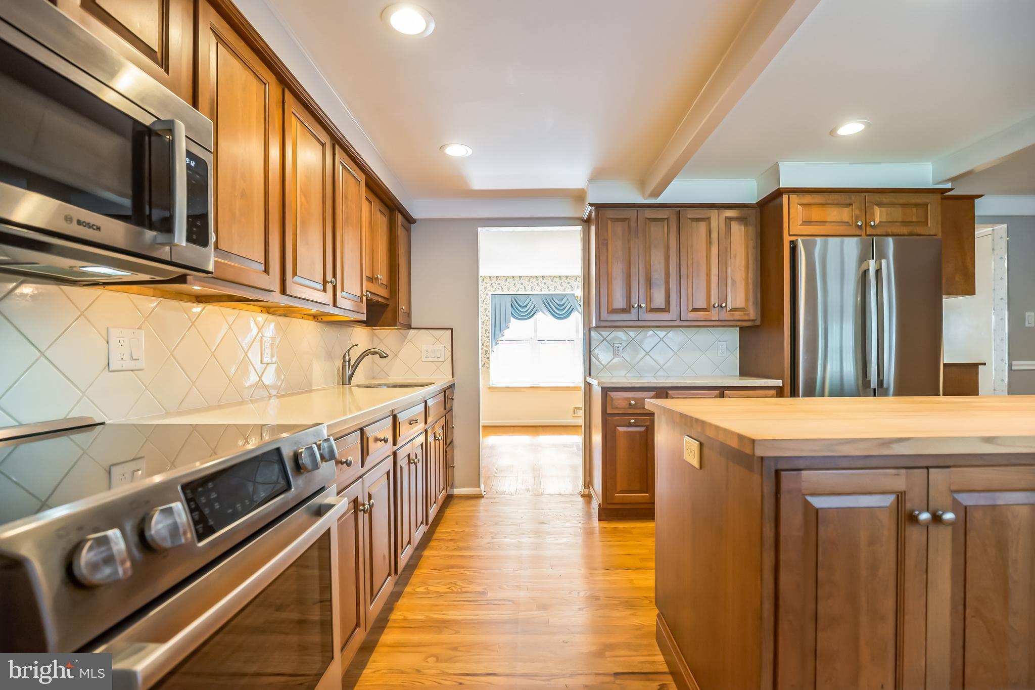121 Rockingham Road Cherry Hill, NJ 08034 - Photo 12 of 33 a kitchen with stainless steel appliances granite countertop a stove and a sink