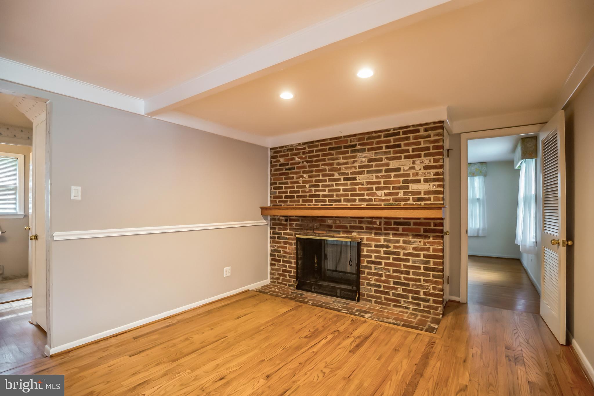 121 Rockingham Road Cherry Hill, NJ 08034 - Photo 15 of 33 a view of empty room with wooden floor and fireplace