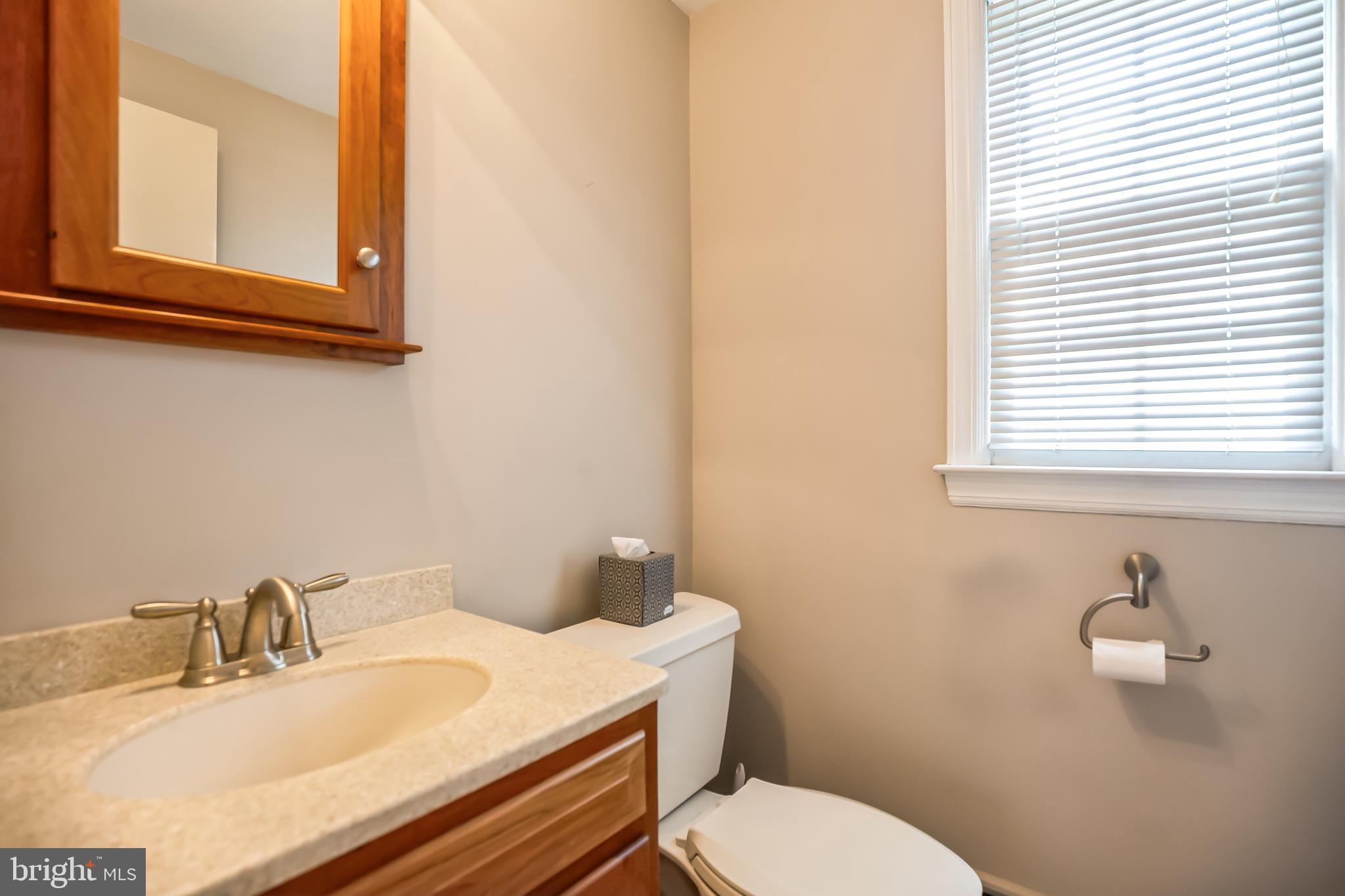 121 Rockingham Road Cherry Hill, NJ 08034 - Photo 17 of 33 a bathroom with a sink vanity mirror and toilet
