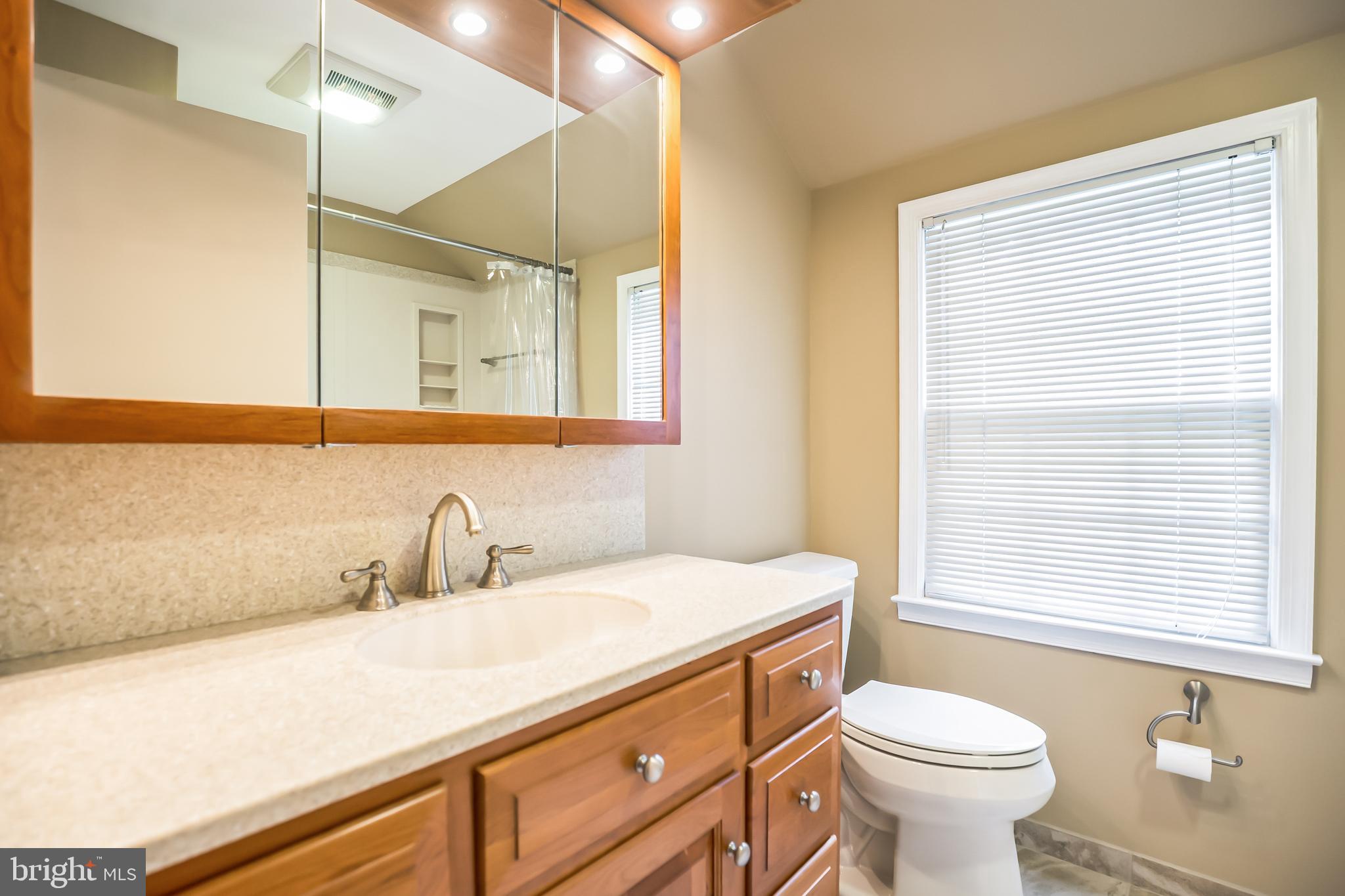 121 Rockingham Road Cherry Hill, NJ 08034 - Photo 20 of 33 a bathroom with a sink a toilet and a window