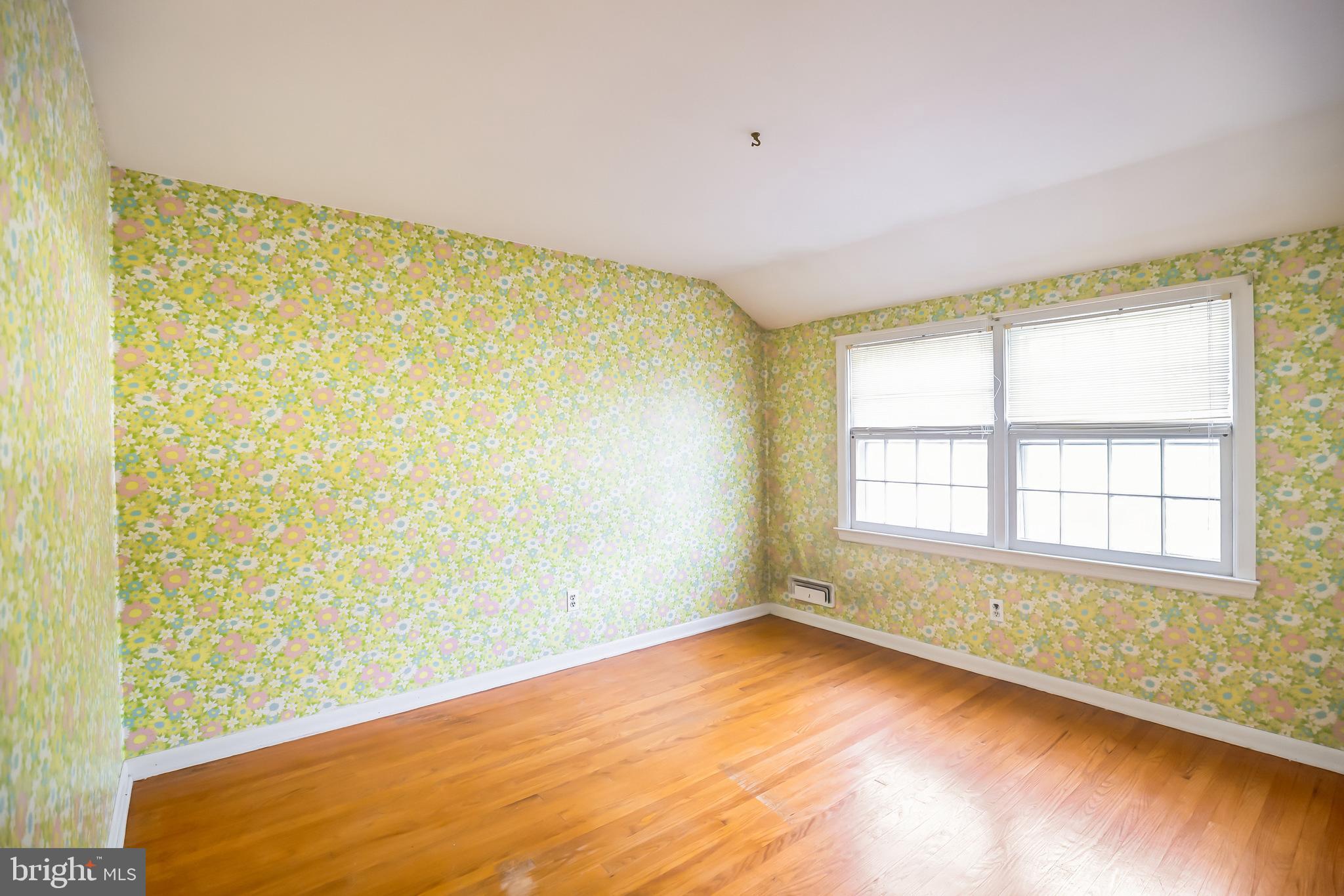 121 Rockingham Road Cherry Hill, NJ 08034 - Photo 27 of 33 a view of an empty room with a window and wooden floor
